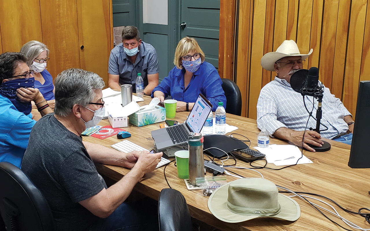 Auctioneer Ric Muscio collects online quilt bids at the microphone July 18 at the West Coast Mennonite Central Committee office in Reedley, Calif. The Celebration for World Relief and Southern California Festival and Sale teamed up to auction quilts online after their annual events were canceled. — Laura Stephenson/Southern California Festival and Sale