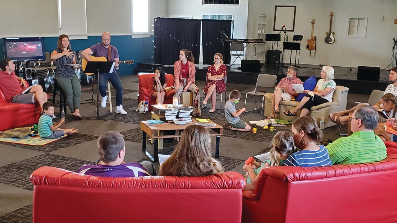 Journey Mennonite Church's Yoder, Kan., campus worships in mid-June in a "living room" setup with families sitting by household under COVID-19 distancing guidelines. — Journey Mennonite Church