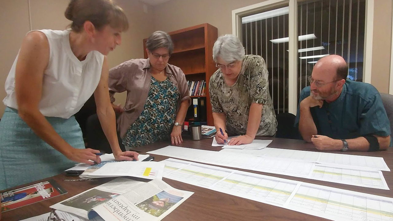 Canadian Mennonite editorial staff — publisher Tobi Thiessen, executive editor Virginia Hostetler, editorial assistant Barb Draper and managing editor Ross W. Muir — plan the magazine’s production schedule in 2018. — Canadian Mennonite