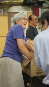 Ann Graber Hershberger and MCC U.S. board member Sunoko Lin (back) of Lake Balboa, Calif., helped to pack boxes of prisoner care kits in 2017 at the MCC East Coast Material Resources Center in Ephrata, Pa. Hershberger will be acknowledged and blessed as the next MCC U.S. executive director at “Celebration 2020: MCC at 100” Oct. 17. — Jill Steinmetz/MCC