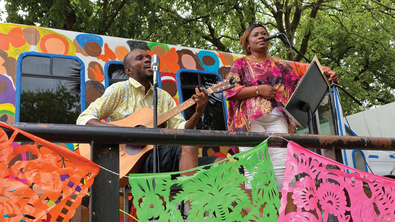 Deo and Kabibi Bamuamba sing in an outdoor community gathering space at San Antonio Mennonite Church. — Katie Best/San Antonio Mennonite Church