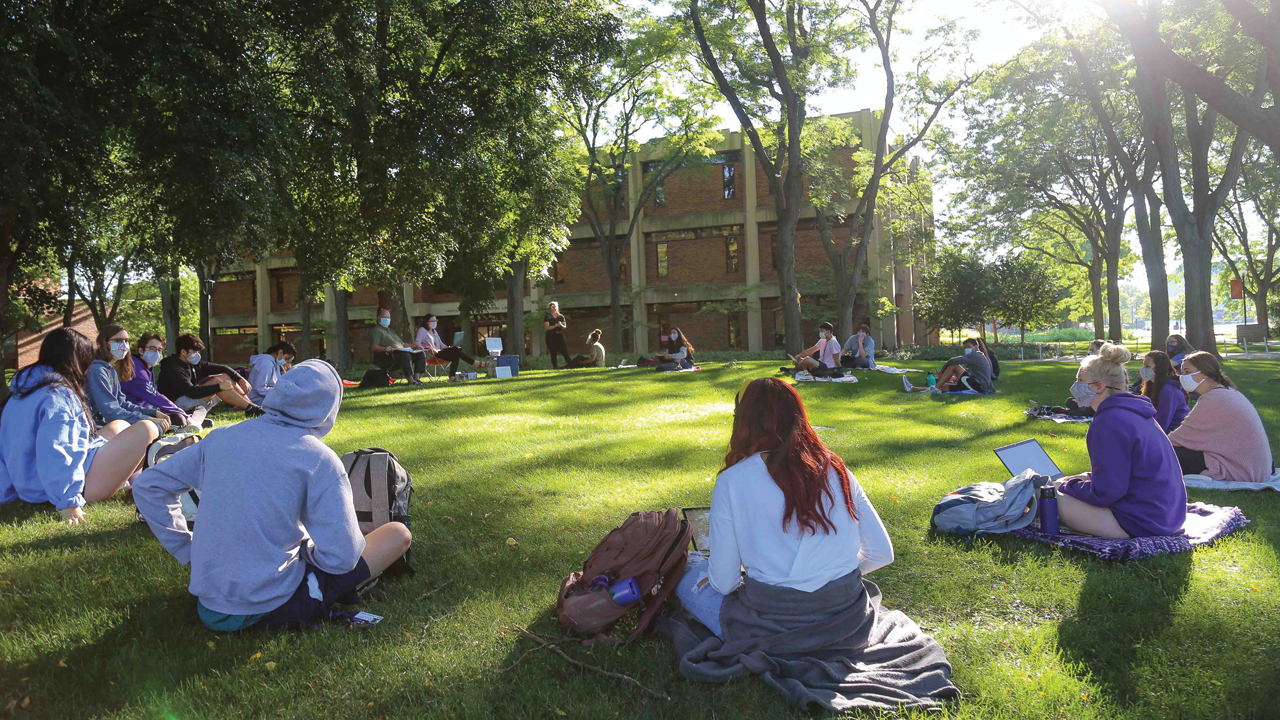 Goshen College students attend a first-year Identity, Culture and Community class outdoors in August. The college has erected several tents around campus for holding classes outdoors as much as possible. — Brian Yoder Schlabach/Goshen College