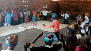 Members of the Mennonite Brethren Church in Malawi pray in September for the Mennonite Brethren Church of India. — International Community of Mennonite Brethren