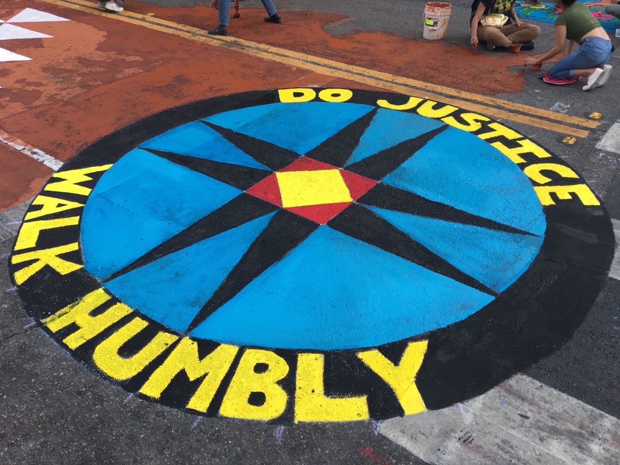 Artists from First Mennonite Church of San Francisco help create a street mural in late October. The church chose a quilt block design in part because quilt making has always been a collective and egalitarian activity, and the Amish eight-point star is similar to the Lakota star. Photo by Jesse Turner