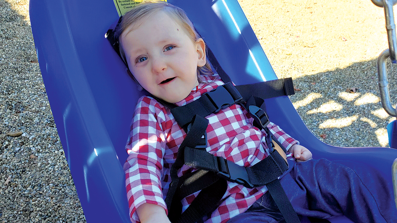 Merida Moody enjoys a new adaptive swing in the playground at Salem Mennonite Church in Dalton, Ohio. — Holly Moody