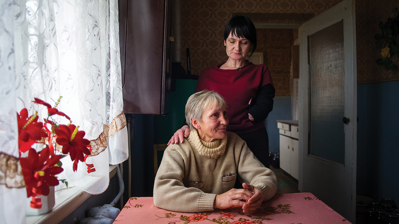 In 2013, in Nikopol, Ukraine, Natalia Mezentseva (standing) of MCC partner New Life meets with Lubov Yarchuk. New Life meets basic needs of those displaced by conflict, or struggling with issues like HIV, addiction or homelessness. — Matthew Sawatzky/MCC