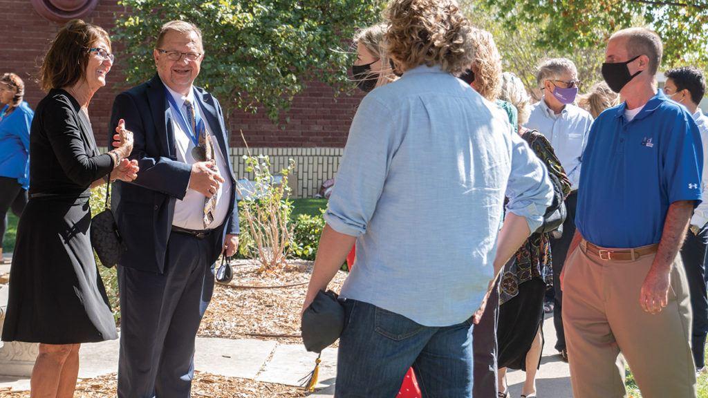Tabor College President Jules Glanzer and his wife, Peg, greet guests after commencement Oct. 11 during homecoming weekend. Spring commencement activities were delayed to the fall due to COVID-19. — Tabor College