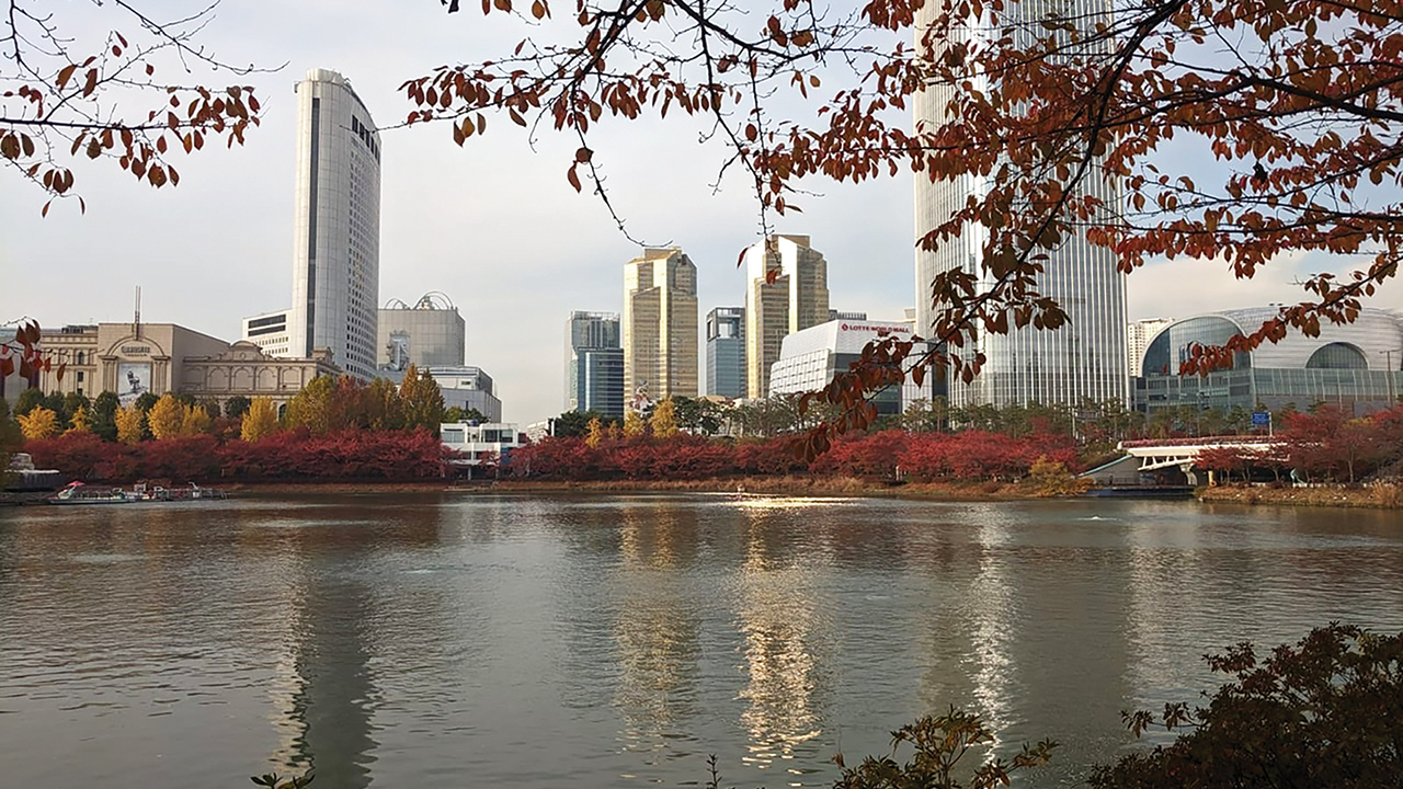 Skyscrapers of Seoul, South Korea, rise behind Seokchon Lake, south of the Han River, which bisects the city. The Lotte Tower, at right, is the world’s fifth-tallest building. — Lane Miller