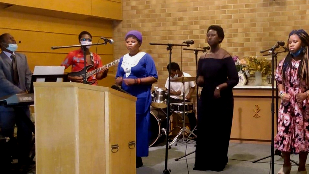 Masemo Wakibogo, left, leads worship at Amani Community Church in Wichita, Kan. — South Central Mennonite Conference
