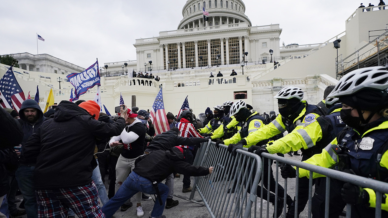Trump supporters try to break through a police barrier on Jan. 6 at the Capitol in Washington. — Julio Cortez/AP