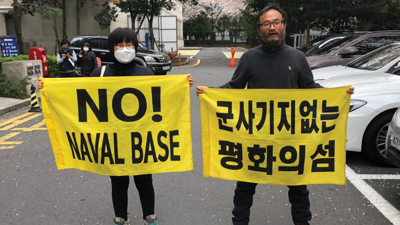 Song Kang Ho, right, protests construction of a naval base on Jeju Island in South Korea with Ryu Bok Hee in early 2020. Ryu was also arrested for entering the base, but received a lesser sentence because she did not cut the fence. — The Frontiers
