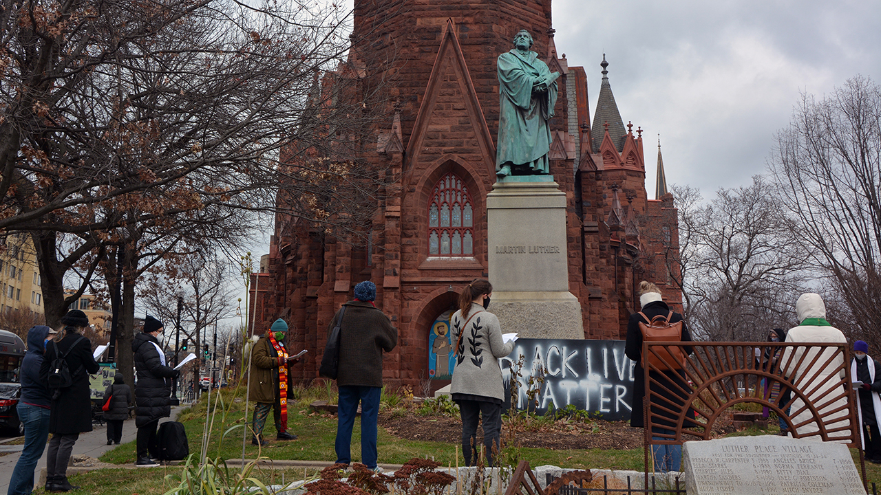 An interfaith group of religious leaders prays outside of Luther Place Memorial Church on Jan. 6 in Washington. — Jack Jenkins/RNS