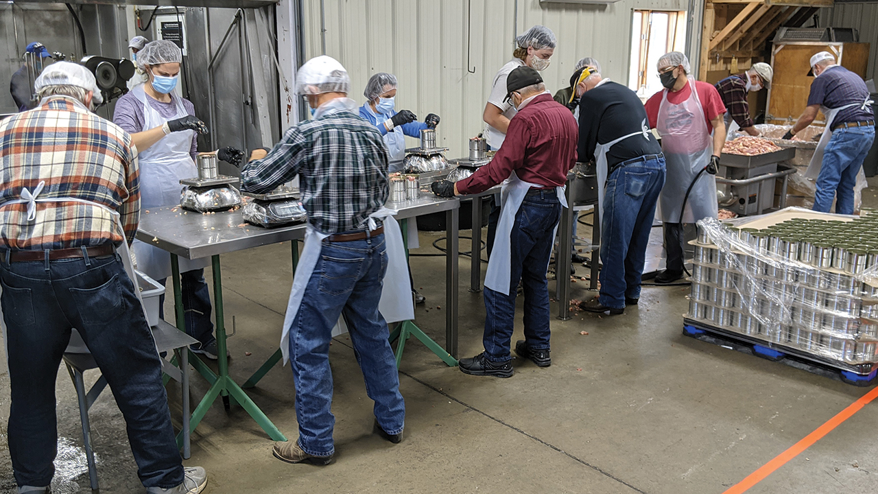 Volunteers process meat on Nov. 11 at the Mennonite Central Committee Material Resources Center in North Newton, Kan. — Heidi Huber/MCC