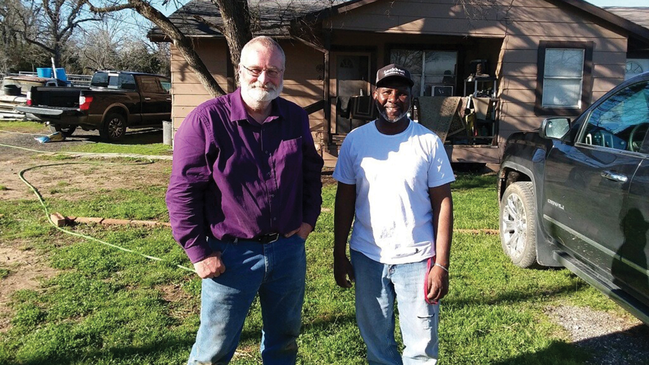 MDS volunteer Doug Casey, left, shares a smile with Casey Waites of Bastrop, Texas, after restoring water in his home. — Mennonite Disaster Service