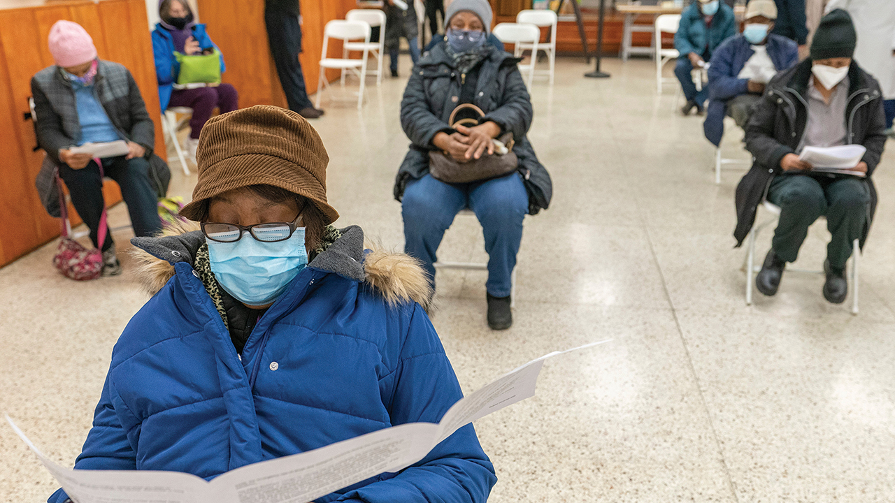 Elaine Chambers reads a coronavirus vaccination pamphlet while resting after receiving the first dose of the vaccine at a pop-up COVID-19 vaccination site at St. Luke’s Episcopal Church on Jan. 26 in the Bronx borough of New York. — Mary Altaffer/AP