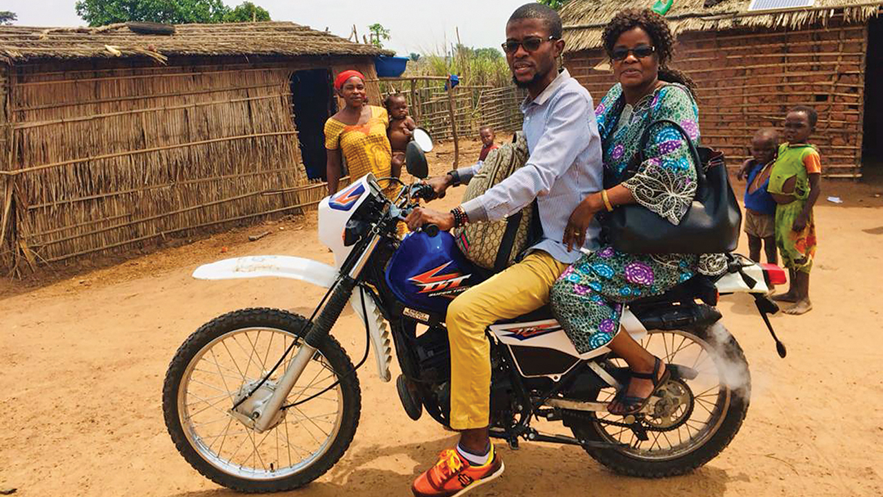 Bercy Mundedi and her son, Serge, traveled by motorbike to encourage people isolated by COVID-19 restrictions. — Mennonite Mission Network