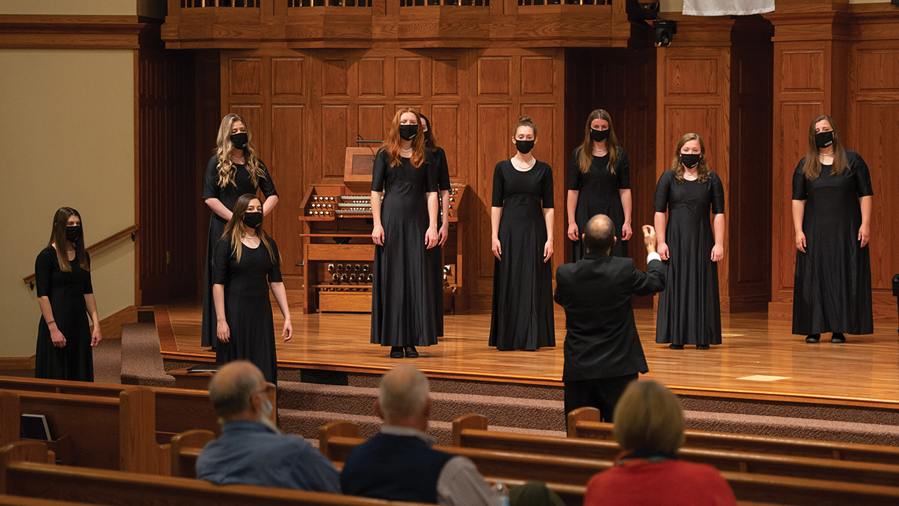 Russell Adrian directs Hesston College’s Bel Canto Singers on April 21 at Hesston Mennonite Church, singing for the Hesston Chamber of Commerce. — Larry Bartel/Hesston College
