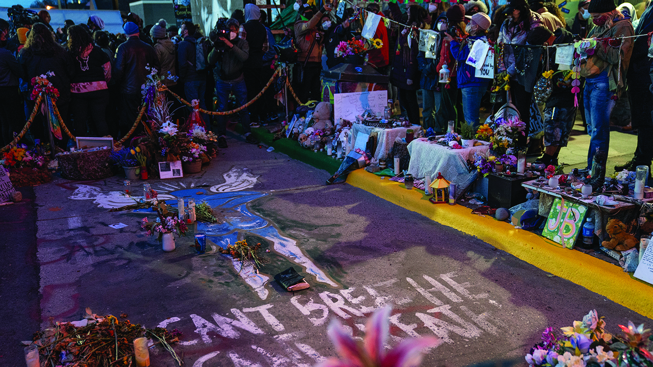 Demonstrators gather around the pavement where George Floyd was murdered to celebrate the conviction of former Minneapolis police officer Derek Chauvin on April 20 in Minneapolis. — John Minchillo/AP