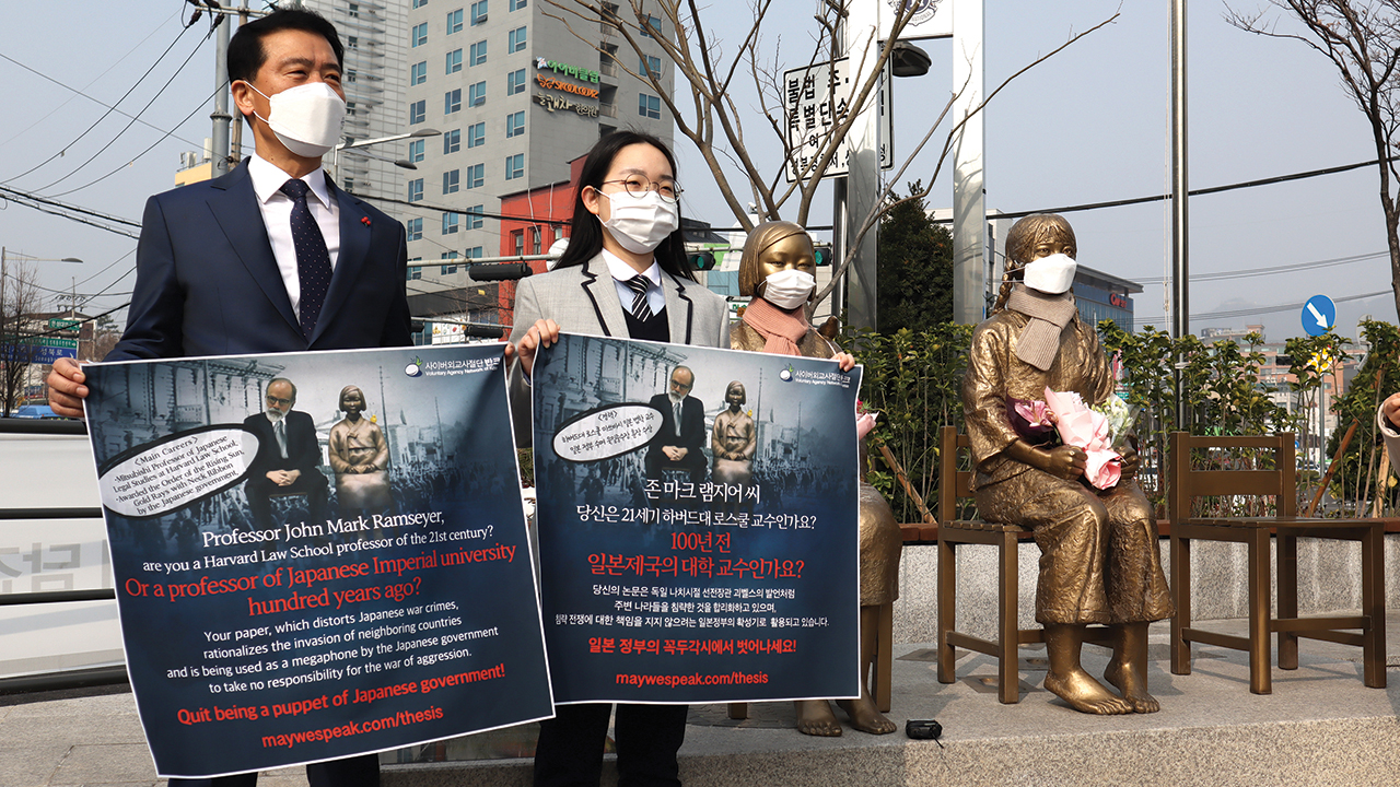 Members of Voluntary Agency Network of Korea, an online organization of young people who share about their nation with people in other countries, hold a demonstration criticizing Harvard University professor J. Mark Ramseyer on March 15 at the Statue of Peace in Seoul, South Korea. Similar statues of “comfort women” exist around the world. — Voluntary Agency Network of Korea