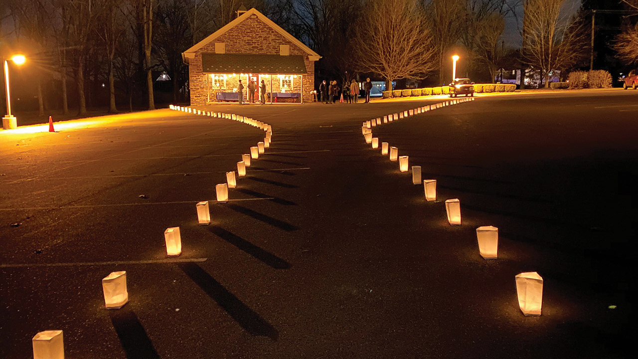 Luminaries lit a path that ended at the historic Salford schoolhouse, built in 1883, where a space for prayer was available. Participants could reflect with art, light a candle and write a prayer to hang on a prayer wall. The prayer wall tags included names of people who died from COVID-19, as well as hopes for the future. — Sondi Good Alderfer