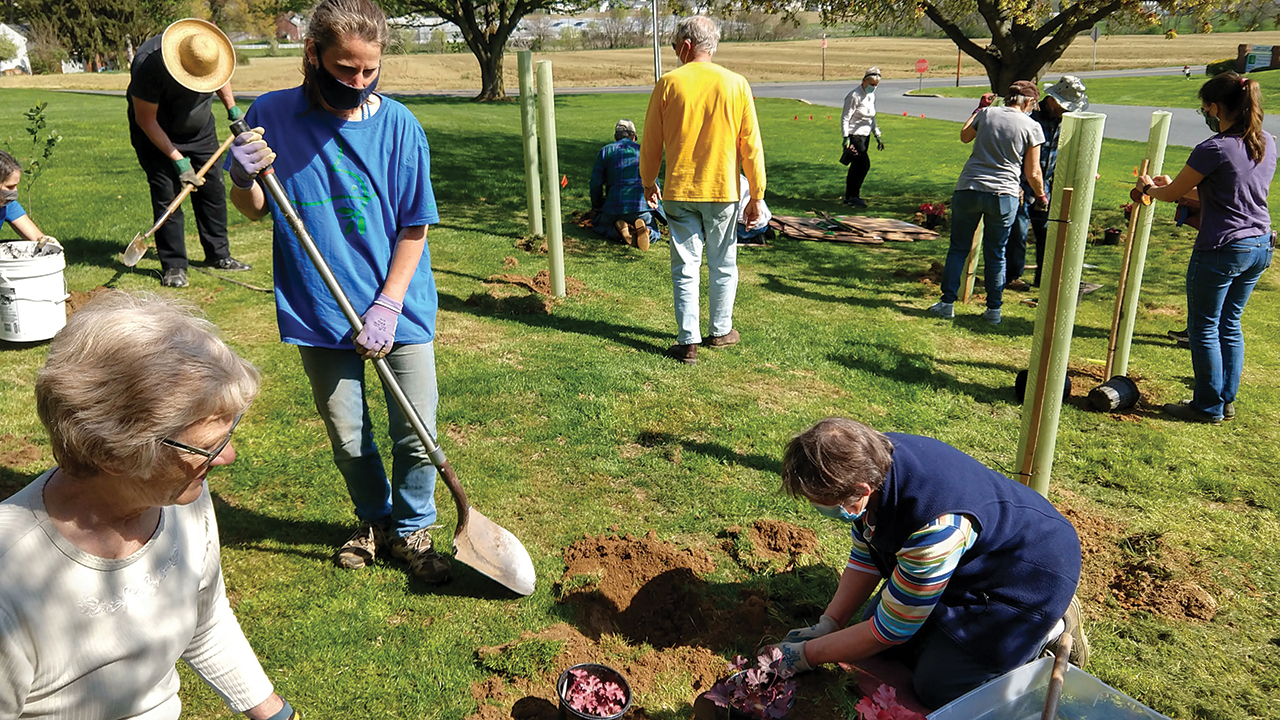Members of Landisville Mennonite Church in Pennsylvania planted a native species demonstration orchard and extended their memorial garden in April. — Chris Fretz/Mennonite Men