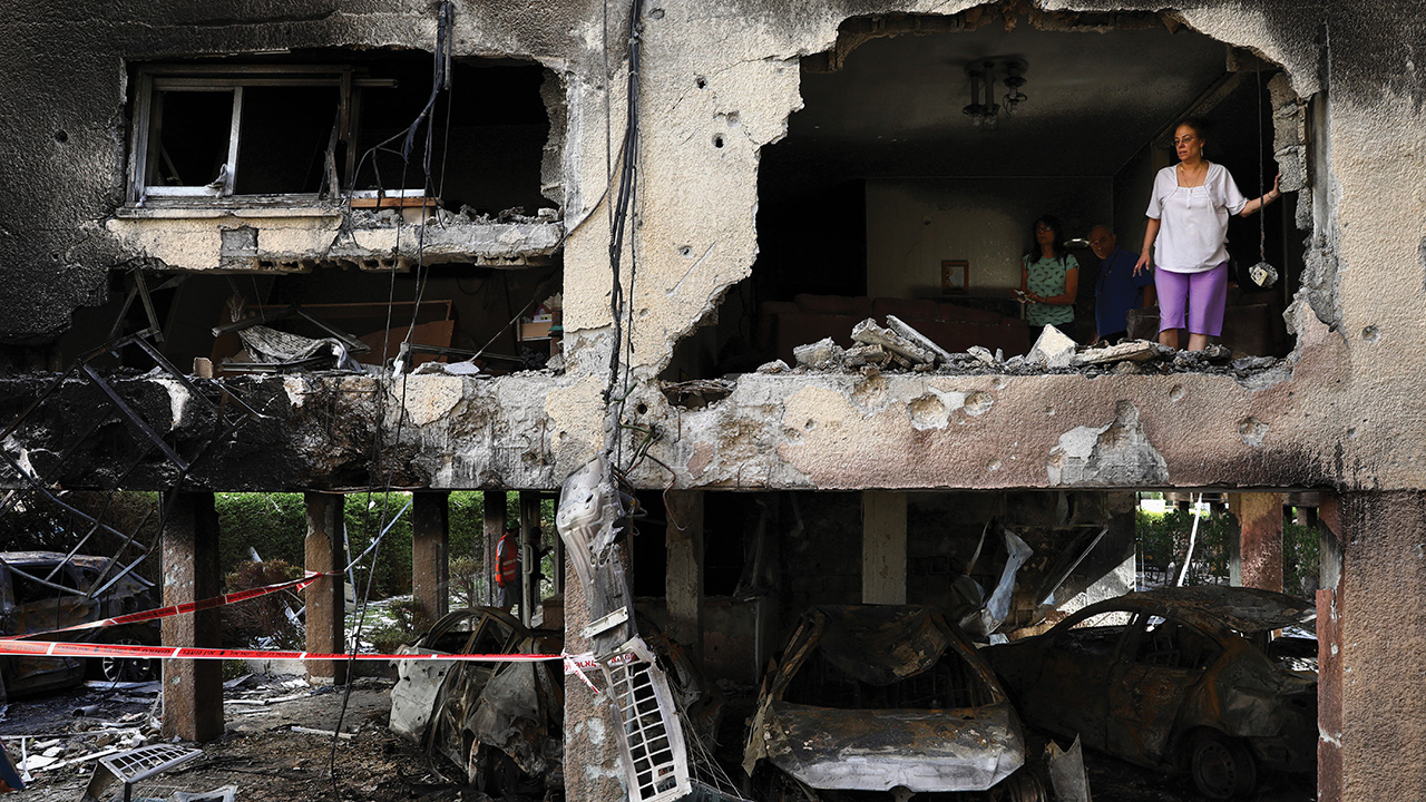 Members of the Sror family inspect the damage of their apartment in Petah Tikva, Israel, after it was hit by a rocket fired from the Gaza Strip on May 13. — Oded Balilty/AP
