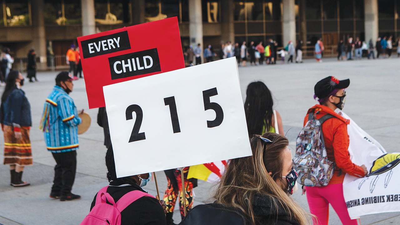 People form a circle during a vigil in Toronto on May 30 for the 215 Indigenous children whose remains were uncovered on the grounds of a former residential school near Kamloops, B.C. — Chris Young/The Canadian Press via AP