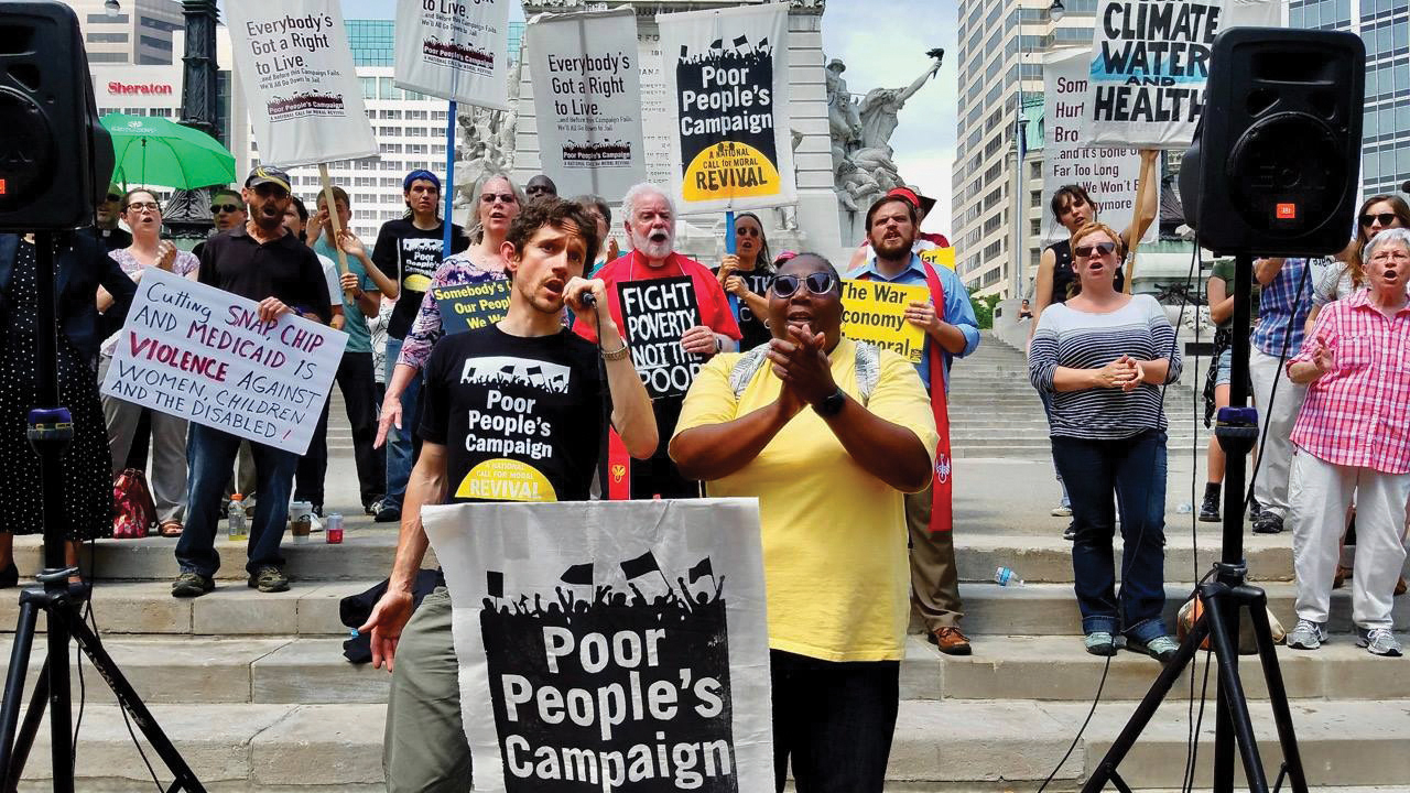 Jason Shenk, left, and Bambi Alridge lead singing at a rally in Indianapolis in May 2018. The rally was part of a nation-wide movement to relaunch the Poor People’s Campaign on its 50th anniversary. — Thomas Frank