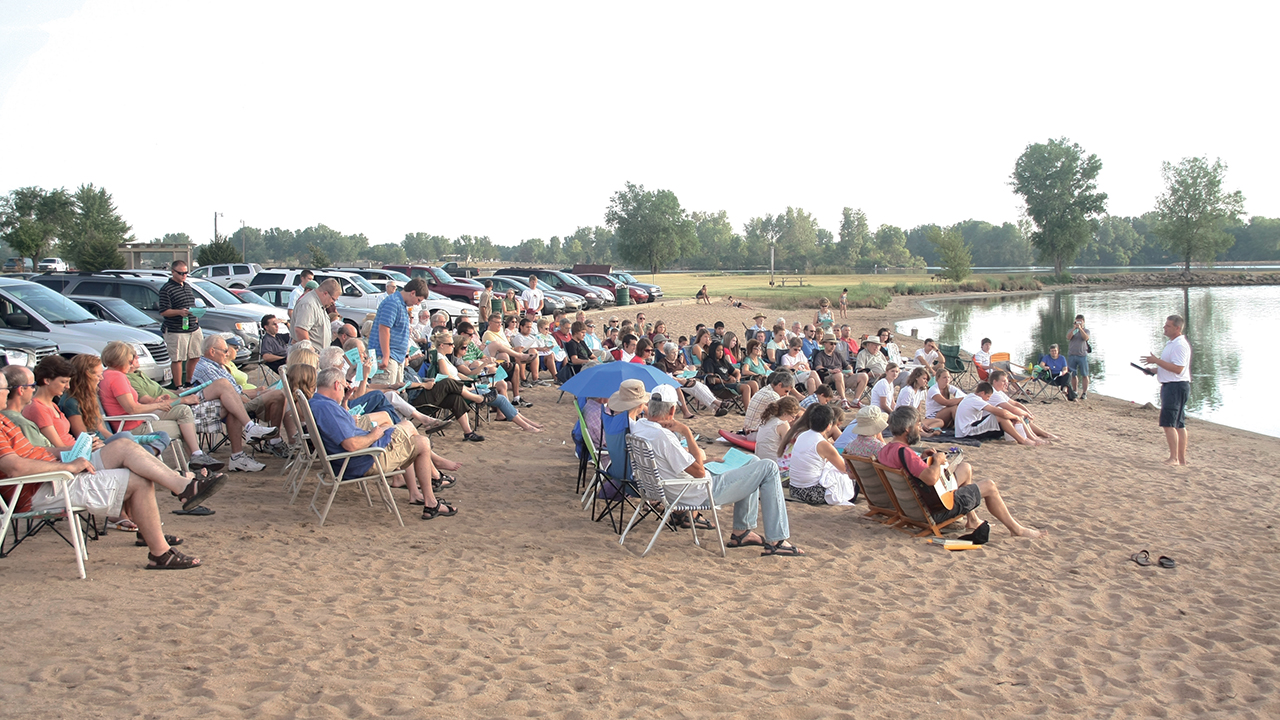 Members of First Mennonite Church in Newton, Kan., gathered at East Lake for a baptism service in 2011. — Rod Wedel