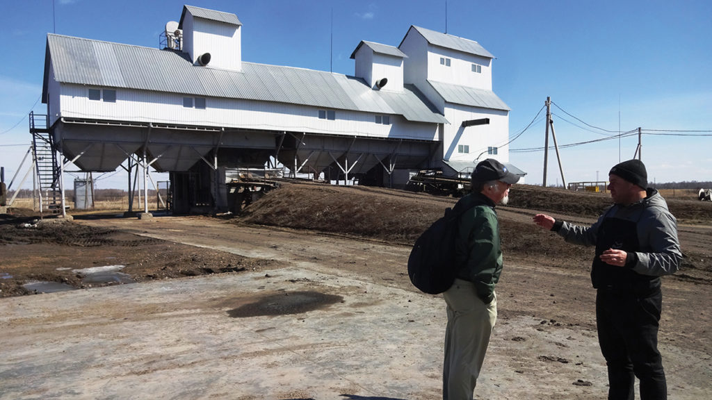 Jakob Dirksen, right, discusses Willock Farm’s feed mill at Medvezhye with journalist William Yoder. — Reinhard Assmann