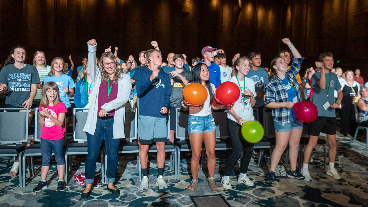 The MennoCon21 crowd responds to worship leaders and musicians in Duke Energy Convention Center. — Mennonite Church USA