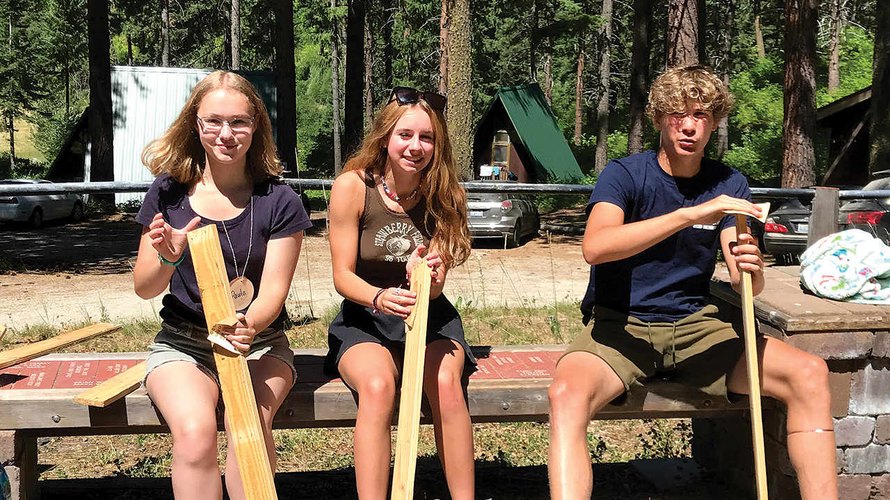 Youth from three Washington Mennonite congregations sand boards that will become a bench during a service project at their convention-themed high school retreat at Camp Camrec. — Amy Epp/Seattle Mennonite Church