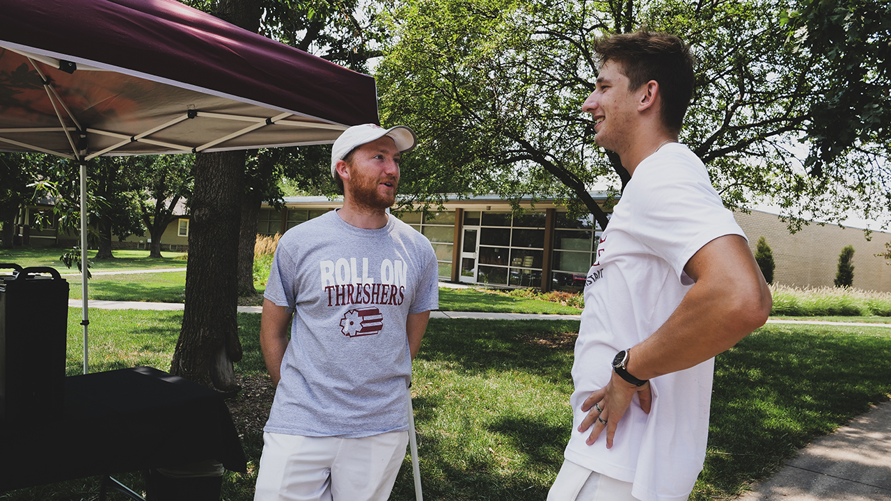 Bethel College tennis coach Gabe Johnson, left, talks to one of his players, Michael Cech, a sophomore from Modlany, Czech Republic, as students move into dorms. — Chase Dempsey/Bethel College