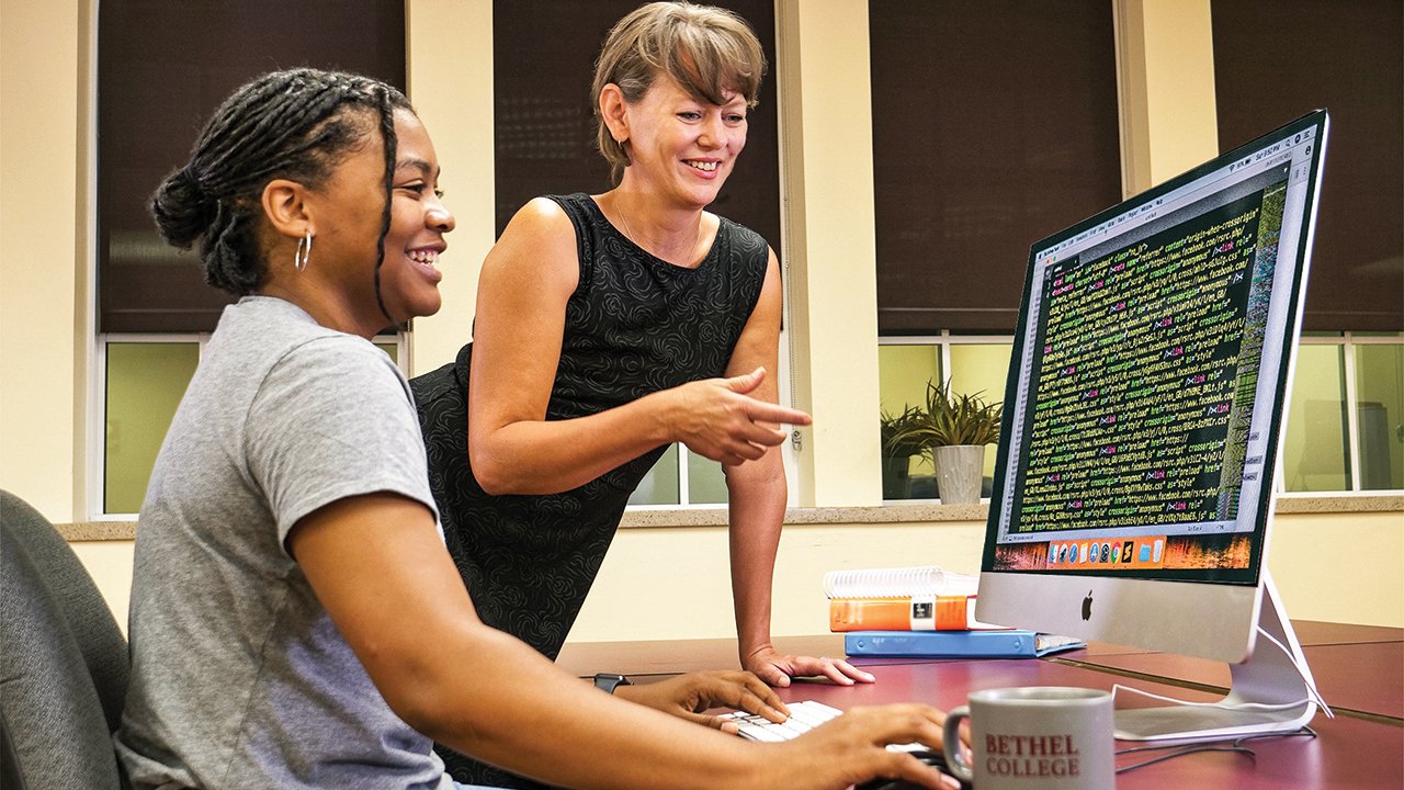 J’Daijon Sumpter, left, international and transfer student admissions counselor at Bethel College, shows Tricia Clark of communications and marketing some of the online resources used in student recruiting. — Chase Dempsey/Bethel College