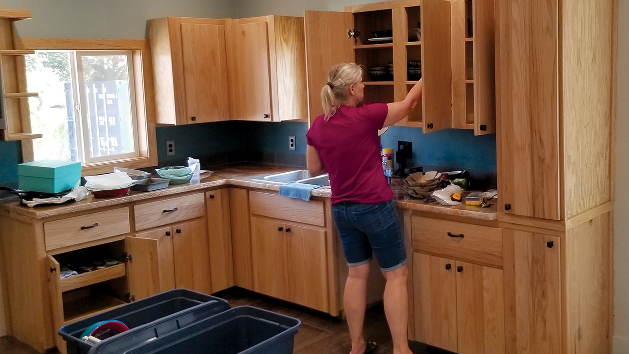 Pascal Hershey moves items into the Filer Mennonite Church parsonage’s new cabinets, built with wood from old pews. — Filer Mennonite Church