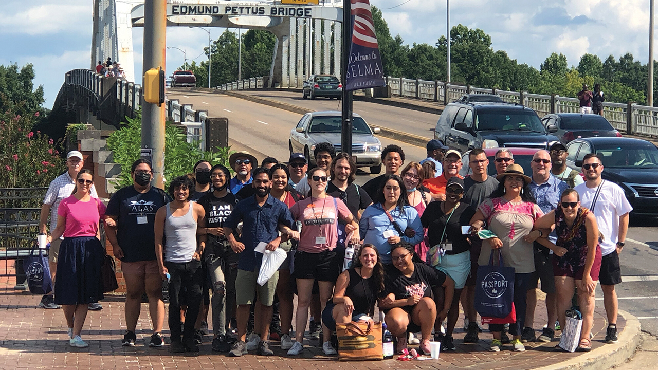 Participants in the Multicultural Peace Collaborative and U.S. Mennonite Brethren denominational leaders stand together in front of the Edmund Pettus Bridge in Selma, Ala., on July 23. The bridge was the site of Bloody Sunday on March 7, 1965, when more than 600 people marching for voting rights were confronted with violent attacks by state troopers. — Saji Oomen