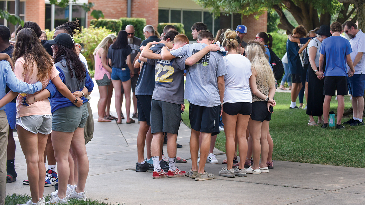 Families and friends pray over first-year students Aug. 14 at the conclusion of freshman orientation. — Michael Klaassen/Tabor College