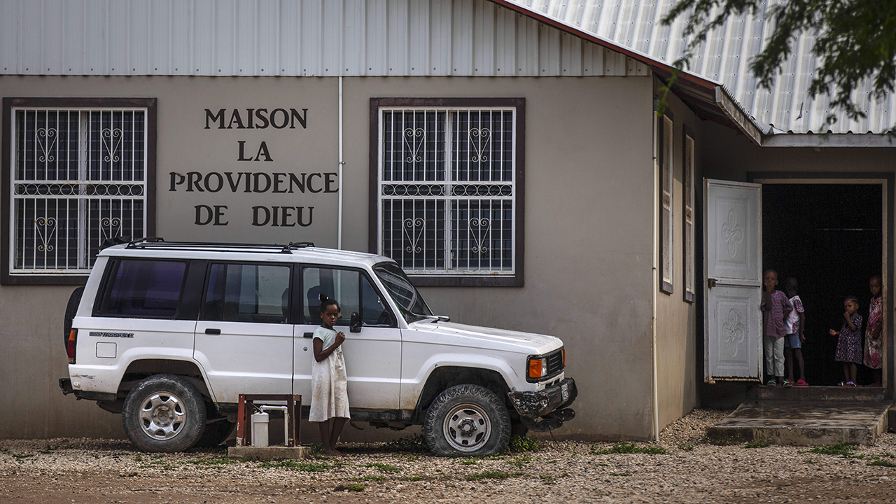 Children stand in the courtyard of the Maison La Providence de Dieu orphanage in Ganthier, Croix-des-Bouquets, Haiti, where a gang abducted 17 workers and family members from Christian Aid Ministries. — Joseph Odelyn/AP