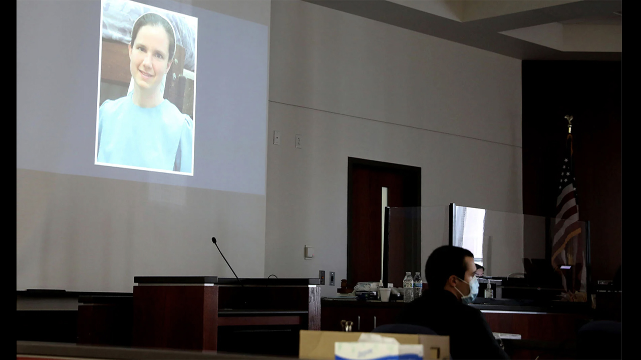 Mark Gooch, 22, sits below an image of Sasha Krause shown on a screen during his trial at the Coconino County Superior Court in Flagstaff, Arizona, on Sept. 24. Gooch was charged with first-degree murder in Krause’s death in early 2020. — Jake Bacon/Arizona Daily Sun via AP