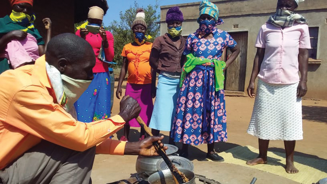 Jawanda Clemence teaches a recipe for mashed lablab to a group of women. Since he entered cooking contests, he has developed his own recipes. — Obert Payenda/Score Against Poverty
