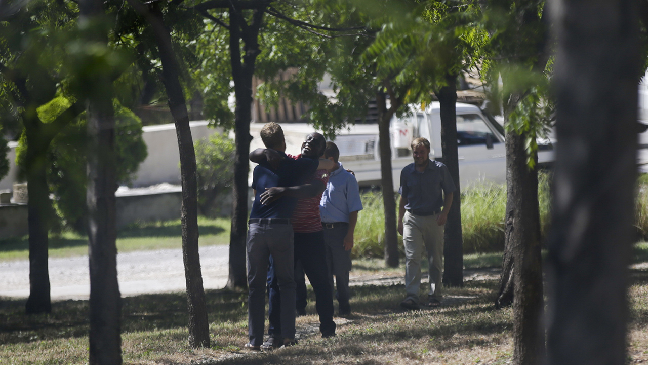 A man embraces a mission worker at the Christian Aid Ministries headquarters at Titanyen, north of Port-au-Prince, Haiti, Dec. 16, 2021. — Odelyn Joseph/AP