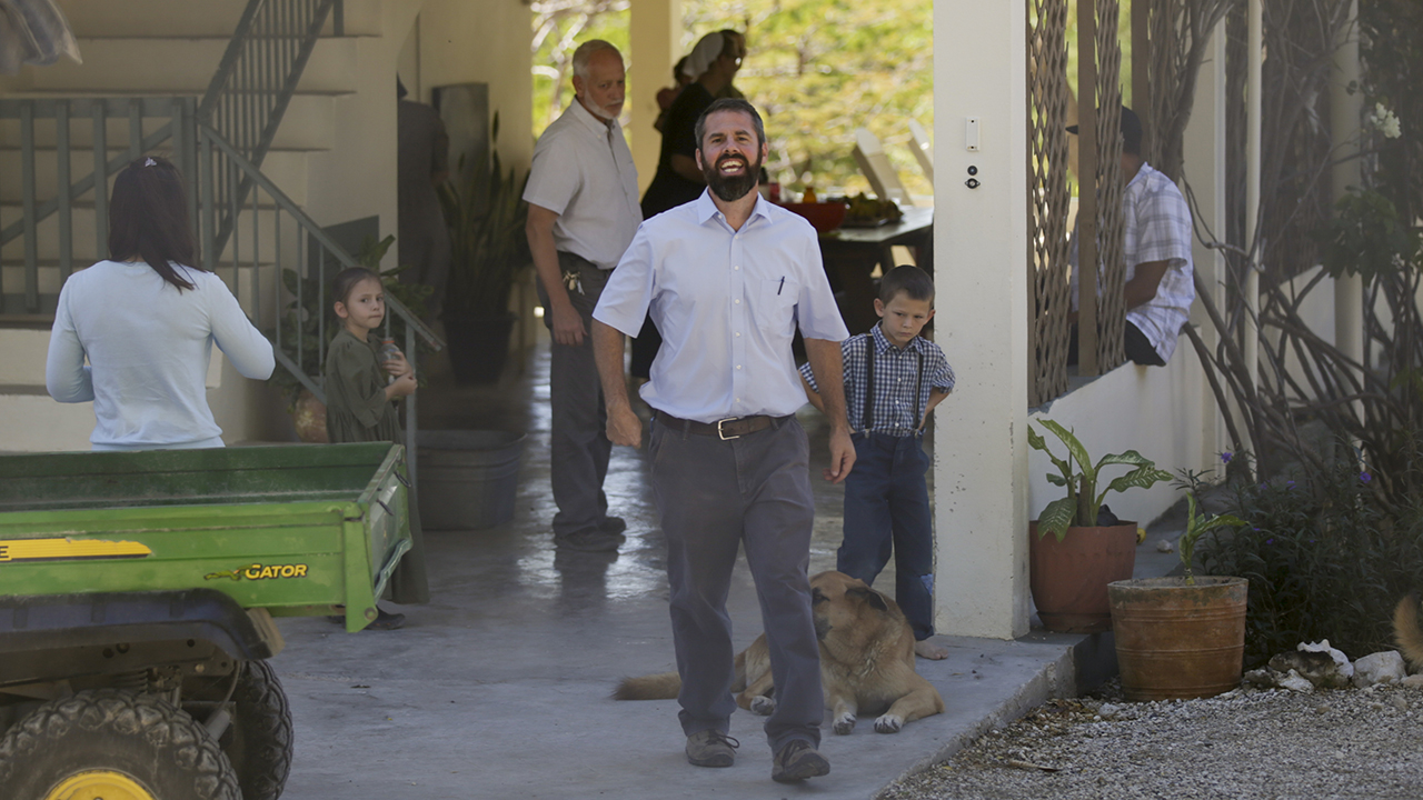 Unidentified people gather Dec. 16 at the Christian Aid Ministries headquarters in Titanyen, north of Port-au-Prince, Haiti. Twelve remaining CAM workers and family members who were kidnapped two months ago have been freed, according to the group and Haitian police. — Odelyn Joseph/AP