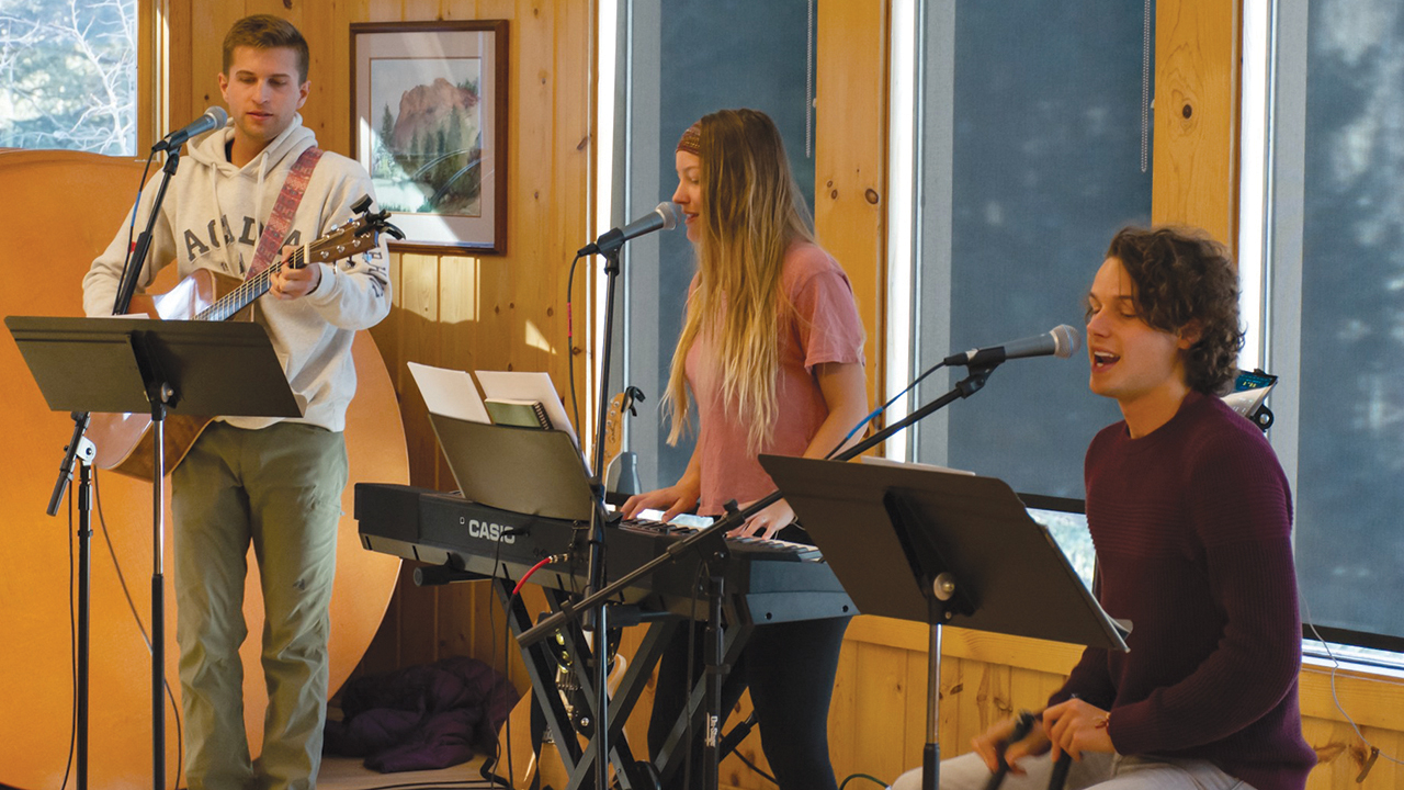 Girl Named Tom — Caleb, Bekah and Joshua Liechty — lead music in a February 2020 worship session during Rocky Mountain Mennonite Camp senior high snow camp. Photo: Rocky Mountain Mennonite Camp