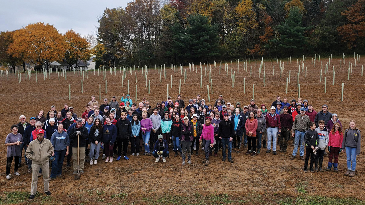 Volunteers from Landisville Mennonite Church and the community pose together after planting 640 trees on the church’s property. — Ryan Davis