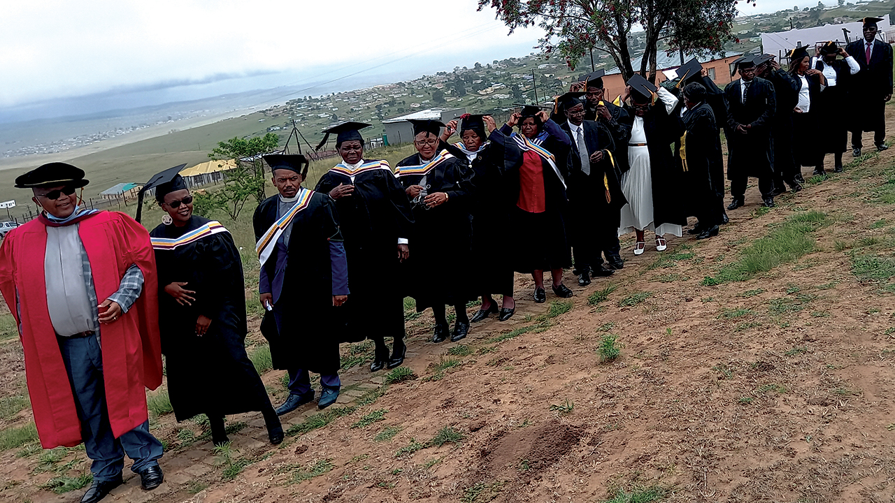 Mennonite Bible School coordinator Reuben Mgodeli gathers with graduates at the institution’s Mthatha branch. — Mennonite Mission Network
