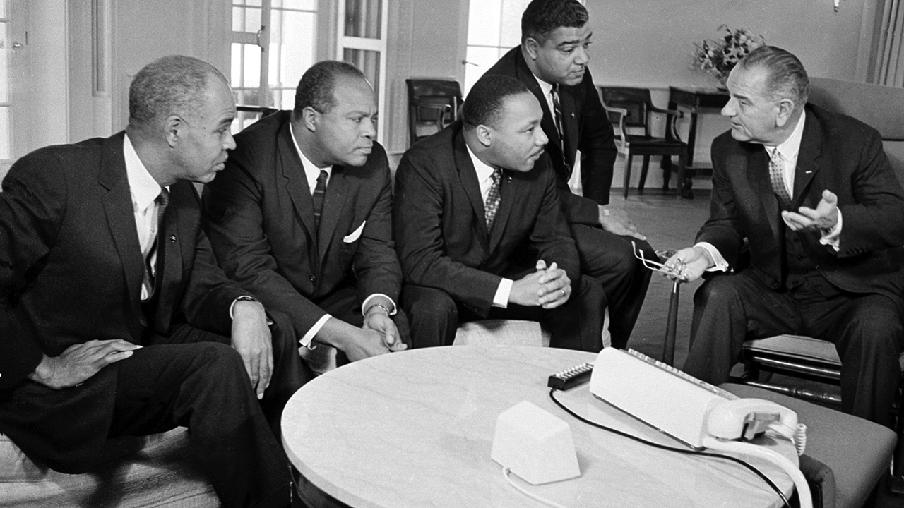 President Lyndon B. Johnson, right, talks with Martin Luther King Jr. and other civil rights leaders in his White House office in Washington, D.C., Jan. 18, 1964. (AP Photo)