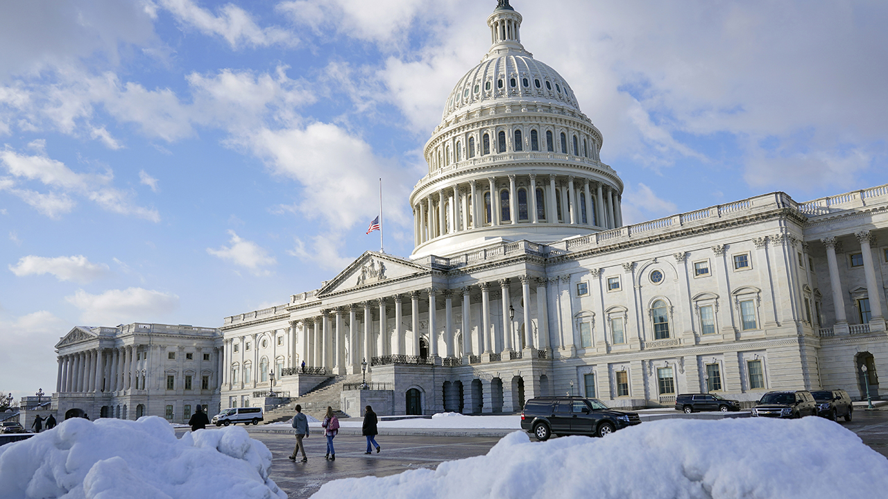 People walk outside the U.S. Capitol building in Washington, Friday, Jan. 7, 2022. — Patrick Semansky/AP