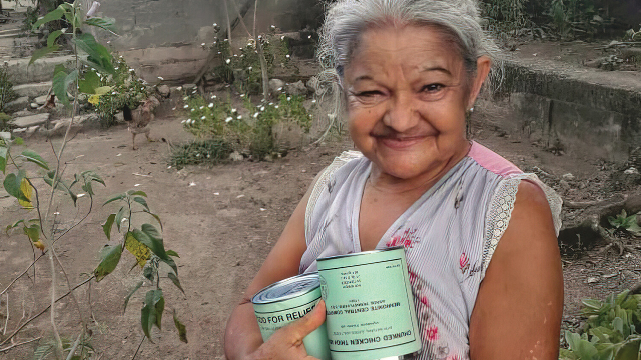 Clara Rodríguez holds cans of MCC canned meat she received through the Brethren in Christ Church of Cuba. — Ramon Guisa/BICCC