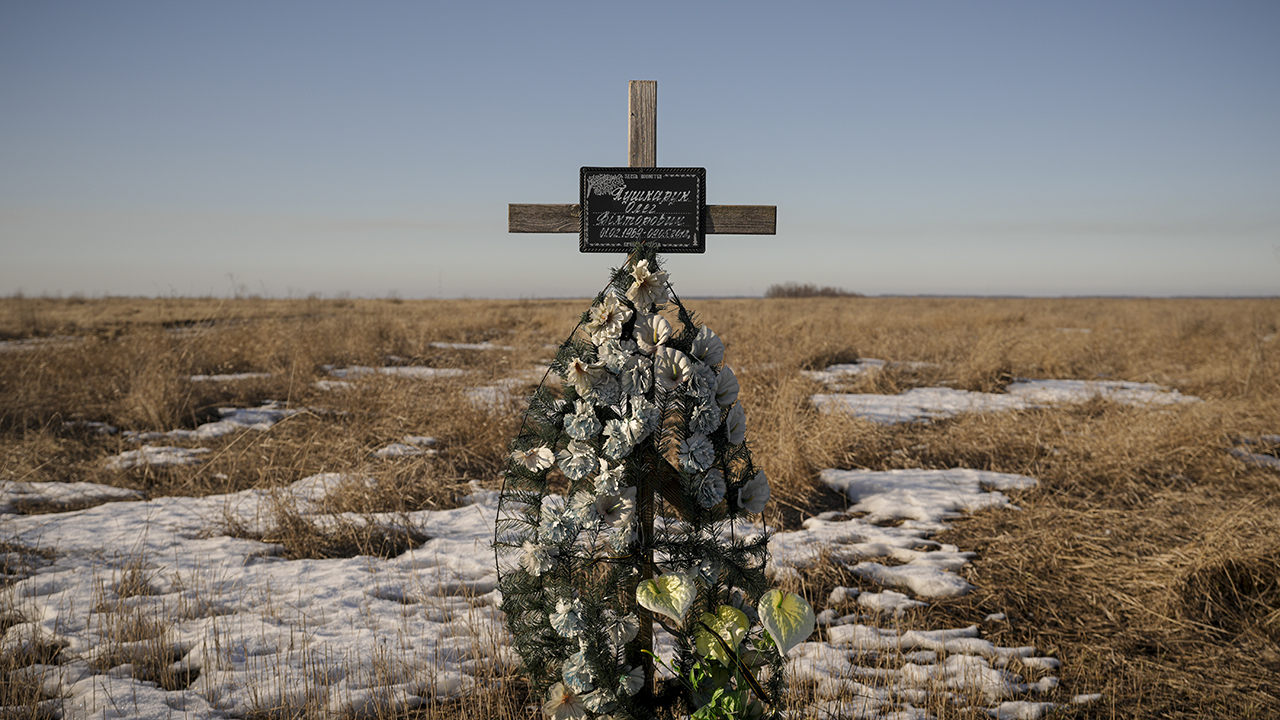 A cross in memory of a Ukrainian soldier is placed in a field near the place he was killed on in 2018, at a front-line position outside Popasna, Luhansk region, eastern Ukraine, Feb. 14. — Vadim Ghirda/AP
