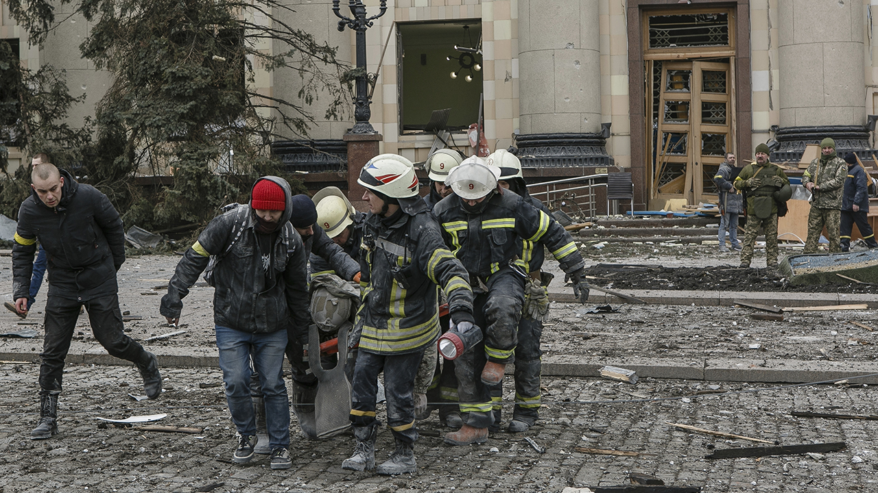 Ukrainian emergency service personnel carry a body of a victim out of the damaged City Hall building March 1 following shelling in Kharkiv, Ukraine. — Pavel Dorogoy/AP